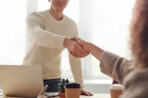 Two professionals shaking hands during a business meeting